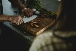 Cheapest 😍 Fiskars Norden Large Cook's Knife 😍 -Alessi shop Fiskars Norden Large cooks knife chopping carrots 1026419